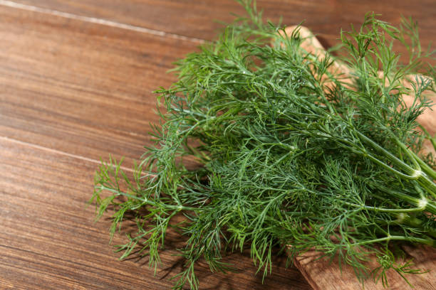 istock Fresh green dill on wooden table, closeup. Space for text 1920925080