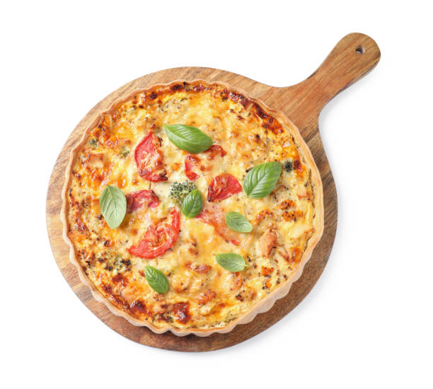 istock Tasty quiche with cheese, tomatoes and basil leaves isolated on white, top view 1920925623