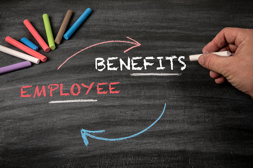 Employee Benefits Concept. Black scratched textured chalkboard background.