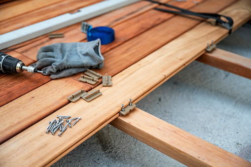 Wooden terrace with work tool on an outdoor deck in the process of being build and renovated.