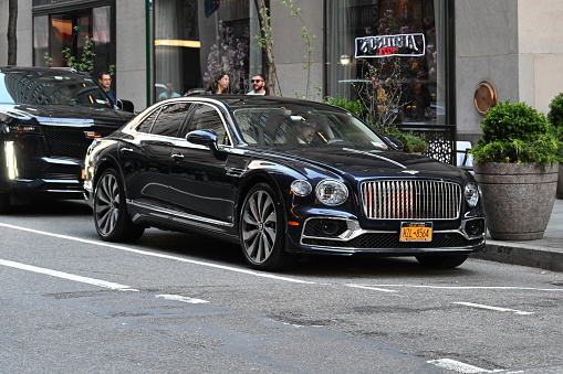 New York City, New York, USA, April 13, 2023 - A black Bentley Flying Spur luxury sedan parked near 5th Avenue in New York.