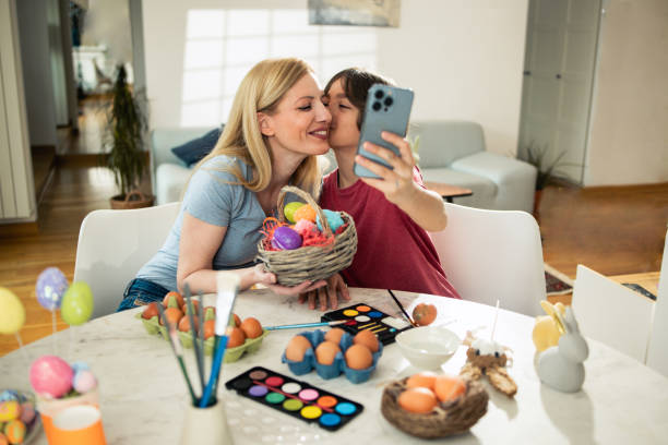 istock Boy and his mom taking a selfie with Easter eggs they've painted 1920938645
