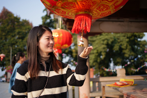 young woman touching lantern