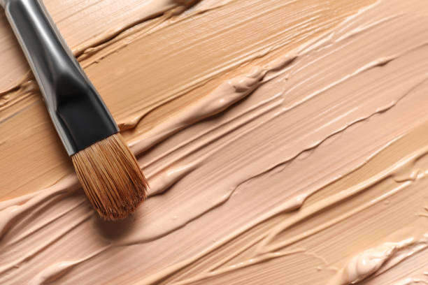 istock Samples of skin foundation and makeup brush, top view 1920978670