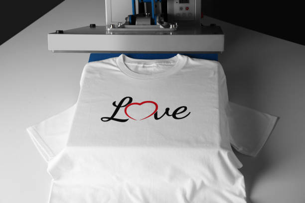 Printing logo. Heat press with t-shirt on white table Printing logo. Heat press with t-shirt on white table t shirt transfer stock pictures, royalty-free photos & images