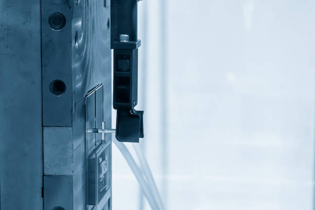istock The material handling process on injection machine holding the injection  part by robotic system. 1921013695