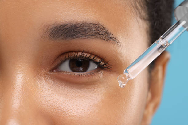 istock Woman applying serum onto her face, closeup 1921021542