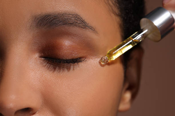 istock Woman applying serum onto her face, closeup 1921022055
