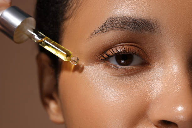 istock Woman applying serum onto her face, closeup 1921023111