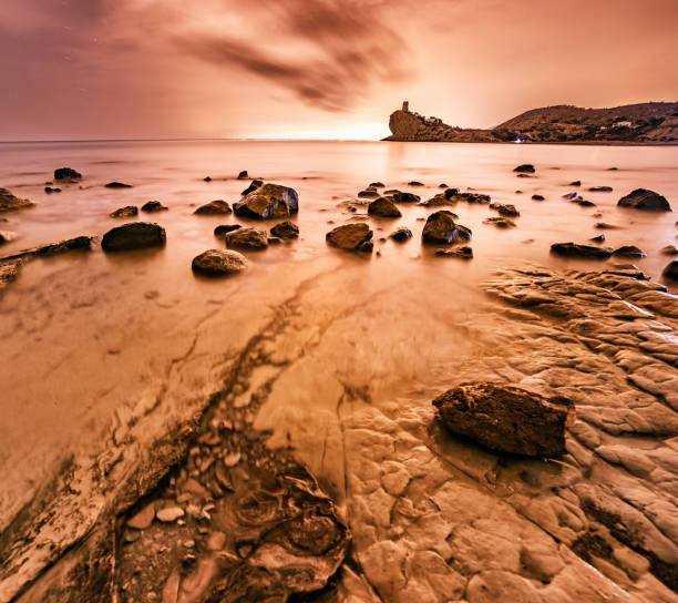 Xarco watchtower in backlight at sunset in Villajoyosa, Valencian Community, Spain