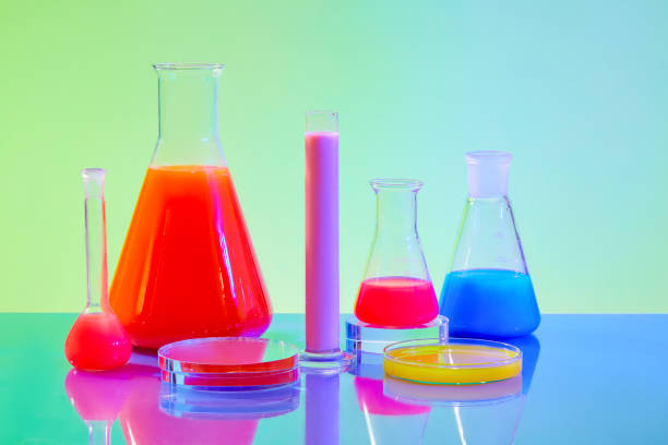 istock Transparent laboratory glassware containing colored liquids on a blue-green gradient background. Laboratory space for advertising with front view. 1921075429