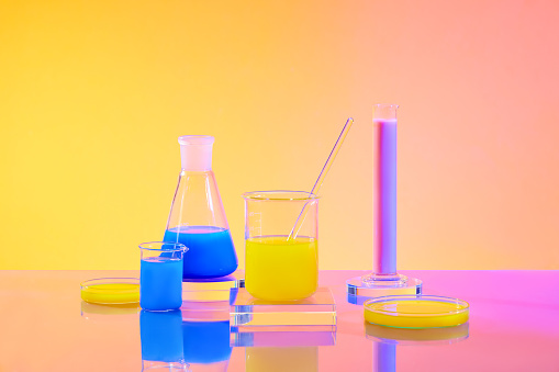 Gavel next to test tubes and beakers with bright colors