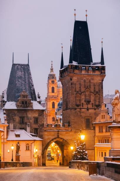 istock Winter twilight in Prague, snow, no one, lights on, Charles Bridge 1921082367