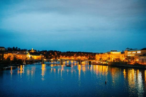istock Winter twilight in Prague, snow, no one, lights on, Charles Bridge 1921083371
