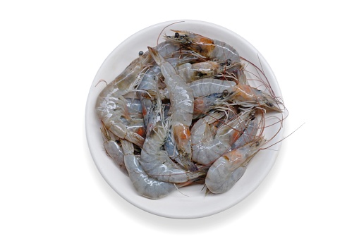 Fresh shrimp tails isolated. Raw headless prawn, pacific shrimp, uncooked tiger prawns, jumbo seafood on isolated background