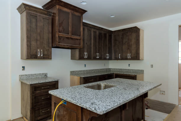 istock New home is under construction with a custom modular kitchen consisting of cabinets an island at its center 1921094571