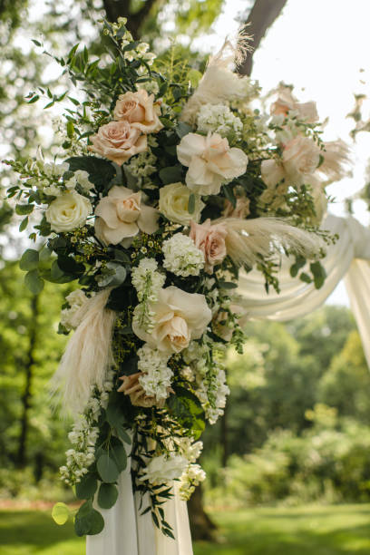 istock Modern floral ceremony arch with roses and wrapped fabric 1921097716