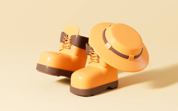 istock Cartoon hiking bootes and hat in the yellow background, 3d rendering. 1921101958