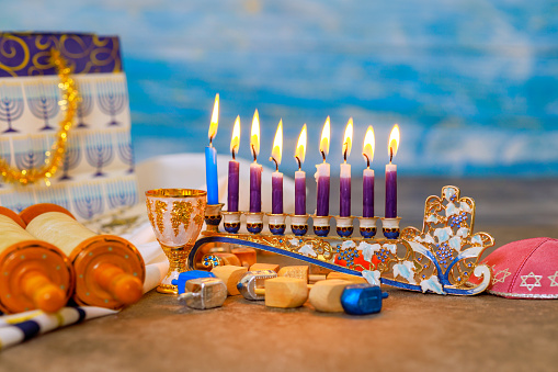 Jewish holiday symbol for Hanukkah is Hanukkiah Menorah with flame burning