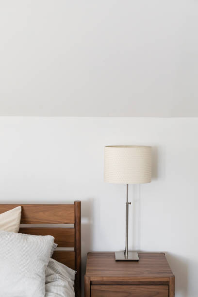 istock Bedroom walnut midcentury nightstand with minimalist lamp 1921110283