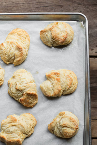 istock Flaky, golden biscuits on parchment paper on wooden table 1921110863