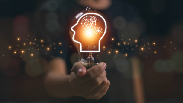 istock Hand holding a glowing lightbulb and human icon thinking for creative thinking ideas and problem-solving concepts. 1921130049