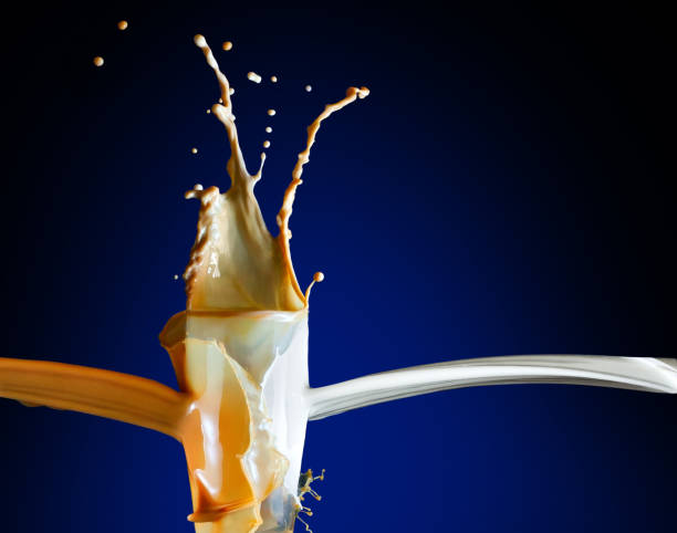 istock Milk coffee splashes from the class on the blue background 1921159196
