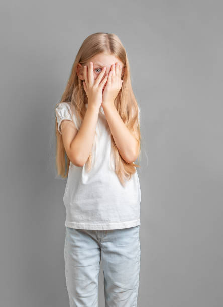 istock A little girl covering her face with her hands 1921287165