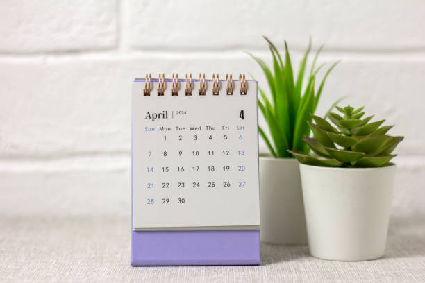 istock Desk calendar for April 2024 and a clock on the table. 1921331174