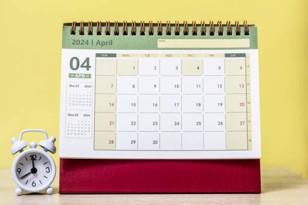 istock Desk calendar for April 2024 and a clock on the table 1921331184