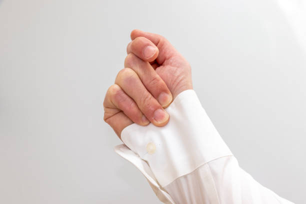 Hold the cuff of a white shirt with fingers