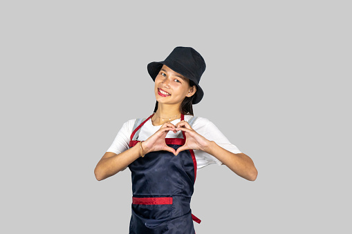An Asian Indian Farmer Nepalese Girl in an apron giving several gestures and expressions of happiness, saddness, pointing etc.