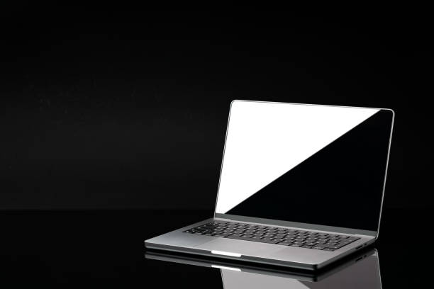 istock Open laptop with black screen against black background 1921357296