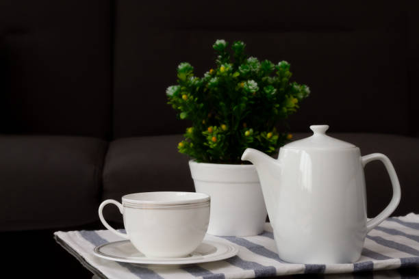 istock White coffee cup and jug with blurred flowerpot put on coffee table 1921360163