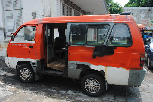 Semarang, Indonesia- 12/27/2023 :\nA dirty old car that still runs in Indonesia.
