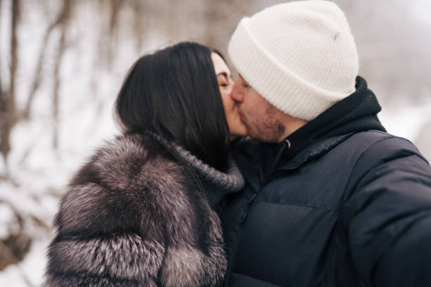 Young couple kissing in the snow