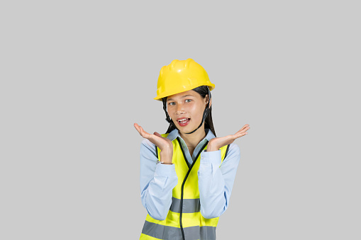 Female  Indian Nepali Asian Construction Worker and Engineer giving expressions and gestures of happiness and excitement and pointing