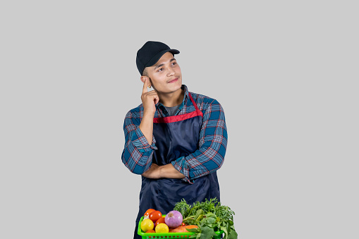 Young Male Asian Muscular Farmer Shows several gestures and expressions along with vegetable harvest