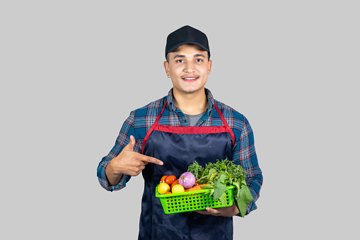 Young Male Asian Muscular Farmer Shows several gestures and expressions along with vegetable harvest