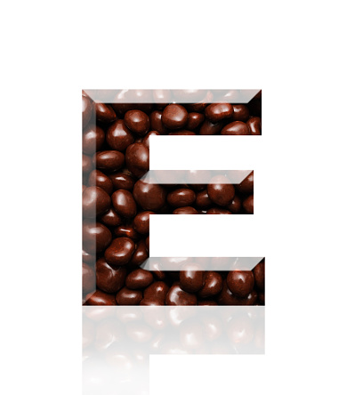 Close-up of three-dimensional chocolate alphabet letter E on white background.