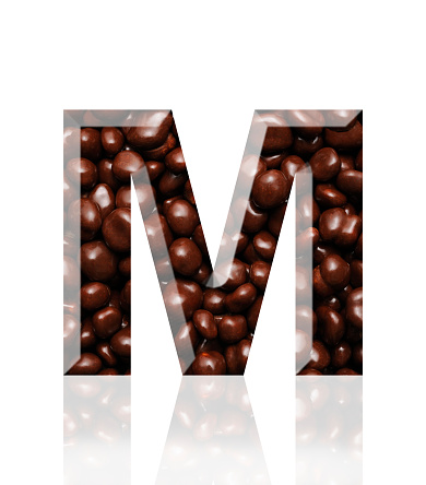 Close-up of three-dimensional chocolate alphabet letter M on white background.