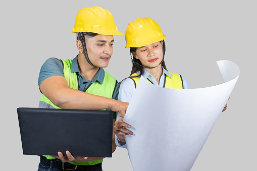 Asian Couple Engineer & Architect gives gestures and expressions on construction field with laptop