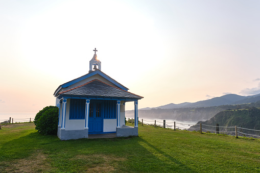 sunrise at the hermitage of la regalina with spectacular views of the atlantic sea and its cliffs.