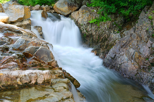 close up on flowing water cascade in the river