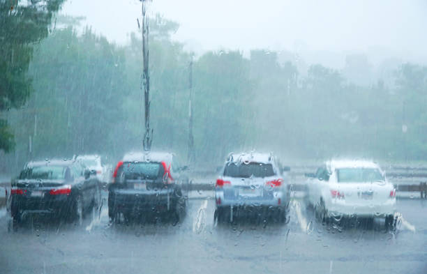 istock vehicles in parking lot in summer thunderstorm with heavy rain 1921463748