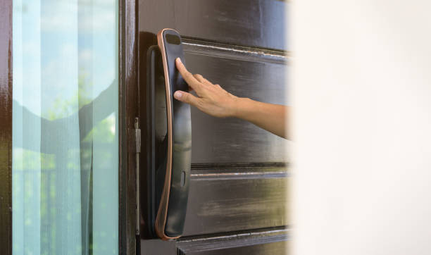 istock Woman push finger down on  fingerprint scanner of smart digital lock while open or close the door at home or apartment. Modern technology access control concept 1921483855