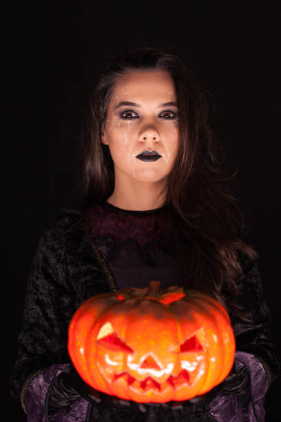 istock Attractive woman with a serious face dressed up like a witch 1921498042