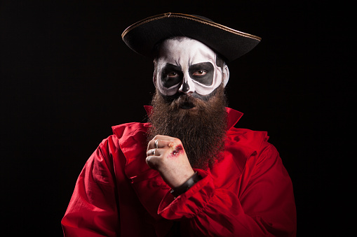 Bearded pirate with long beard wearing a hat . Halloween costume.