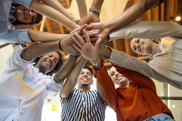 Group of business persons stacking hands in a circle
