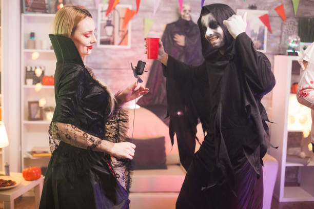 istock Grim reaper and beautiful vampire woman 1921533852